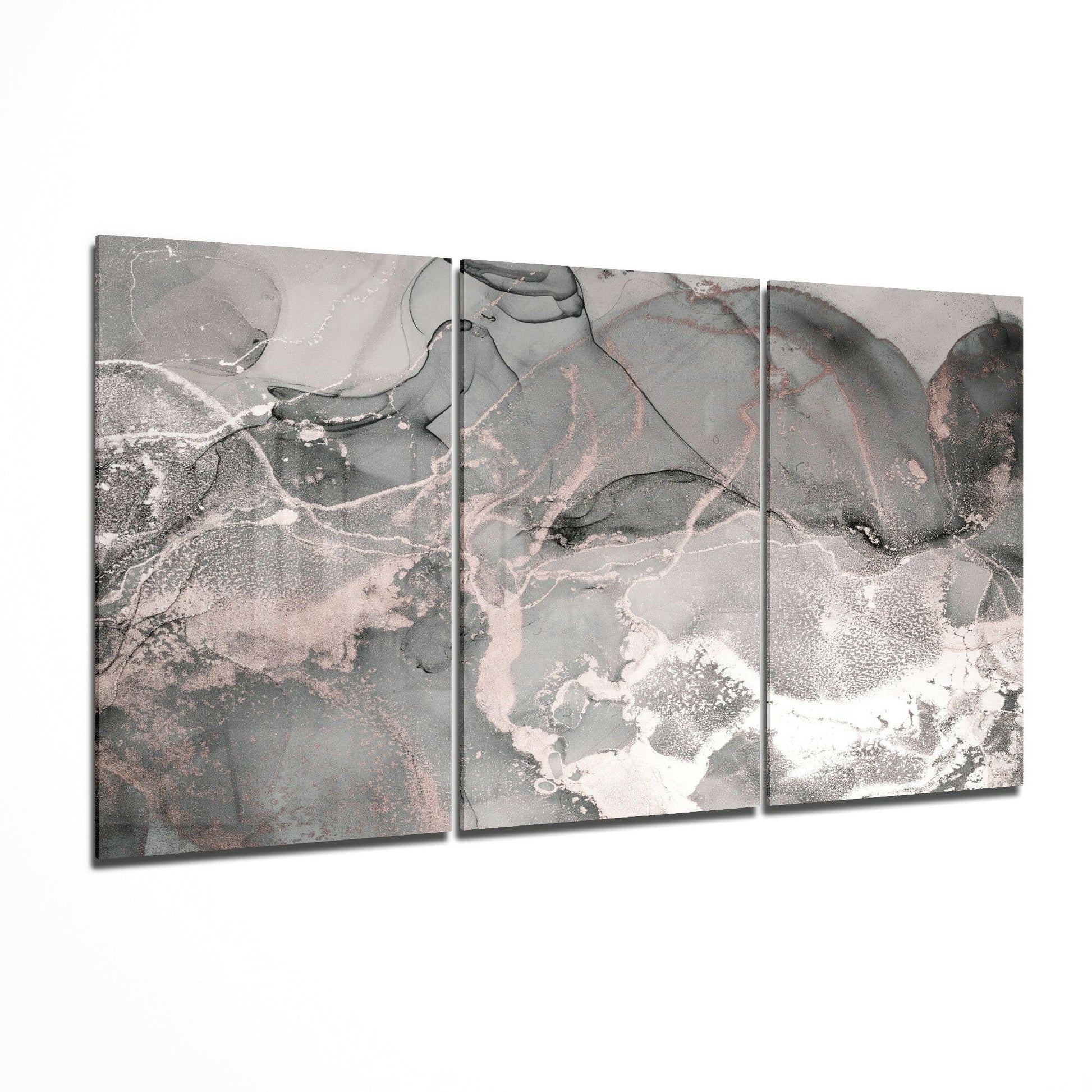 Three-panel gray glass art displaying abstract aerial landscape with white, pink, and dark gray tones and organic flowing patterns.