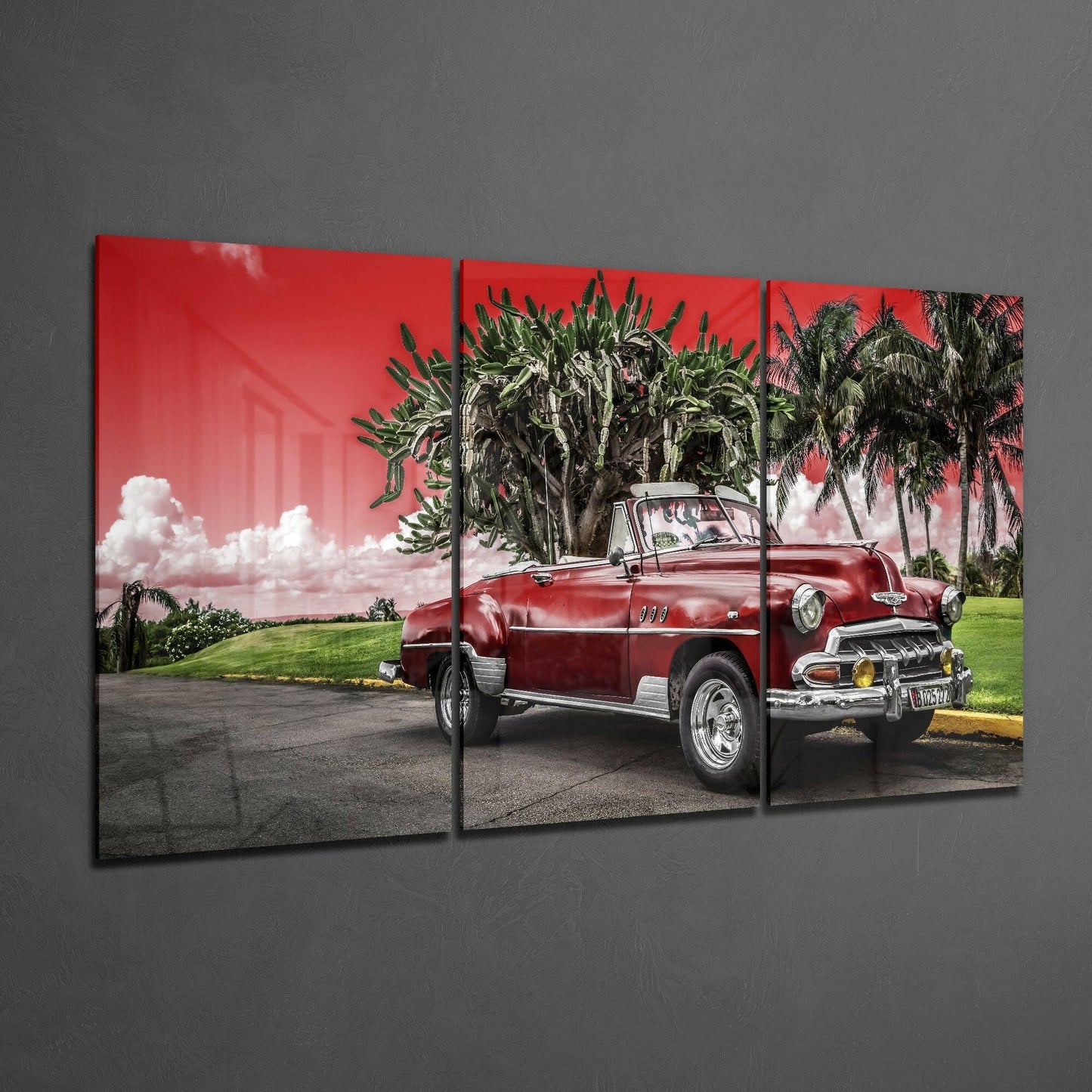 Three-panel glass art displaying a red vintage convertible car parked beneath palm trees against a pink sky.