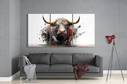 Colorful abstract bull artwork displayed as three-panel glass wall art above gray sofa in modern living room.