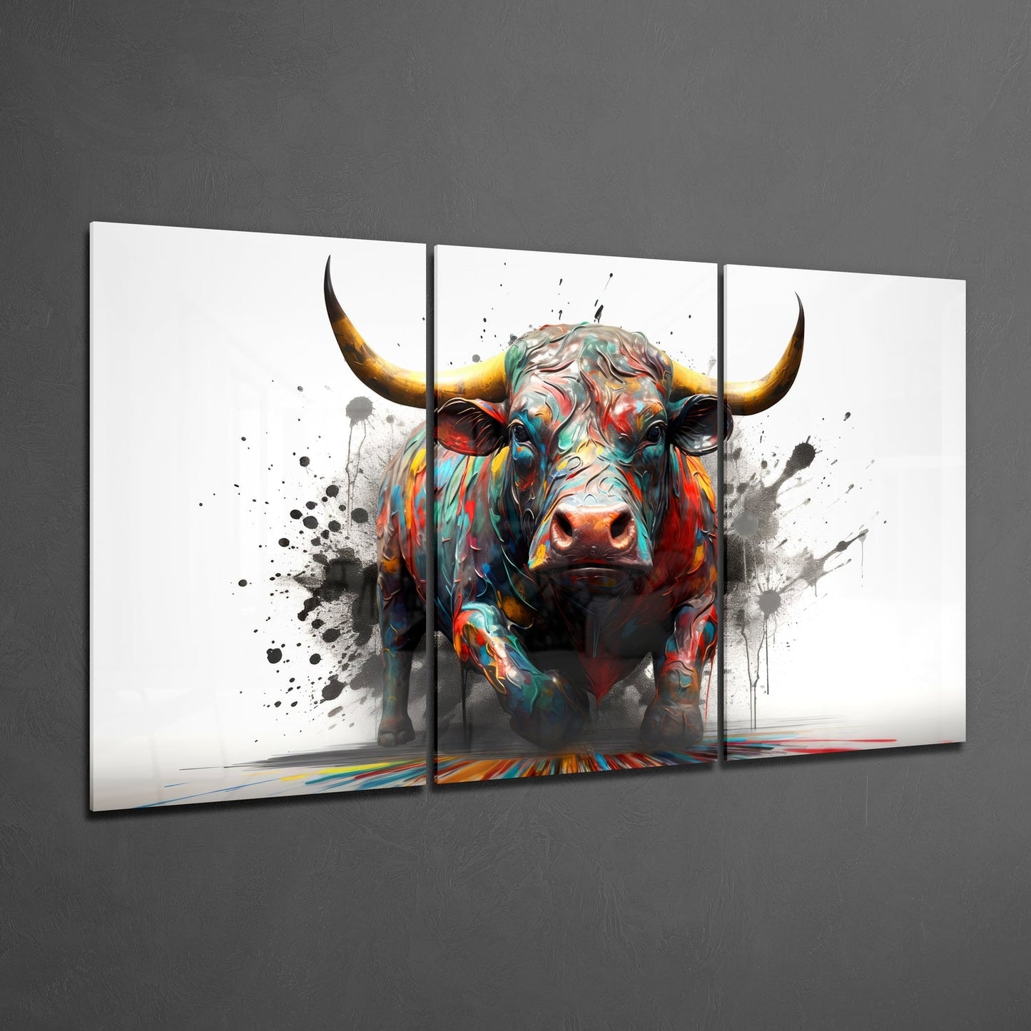 Three-panel glass wall art displaying a colorful bull with golden horns and paint-splatter effects against white background.