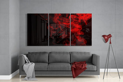 Three-panel red smoke glass wall art displayed above gray sofa in modern living room setting with tripod lamp.