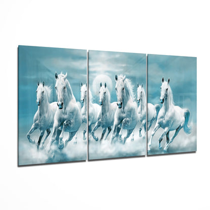 Three-panel glass wall art displaying white horses galloping through clouds against a turquoise sky background.