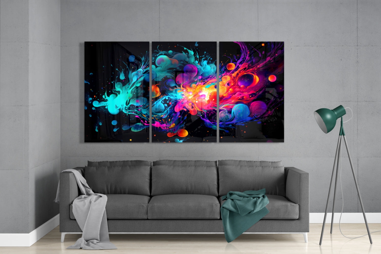 Three-panel abstract glass wall art with vibrant neon cyan, magenta, orange, and purple splashes displayed above gray sofa in modern living room.