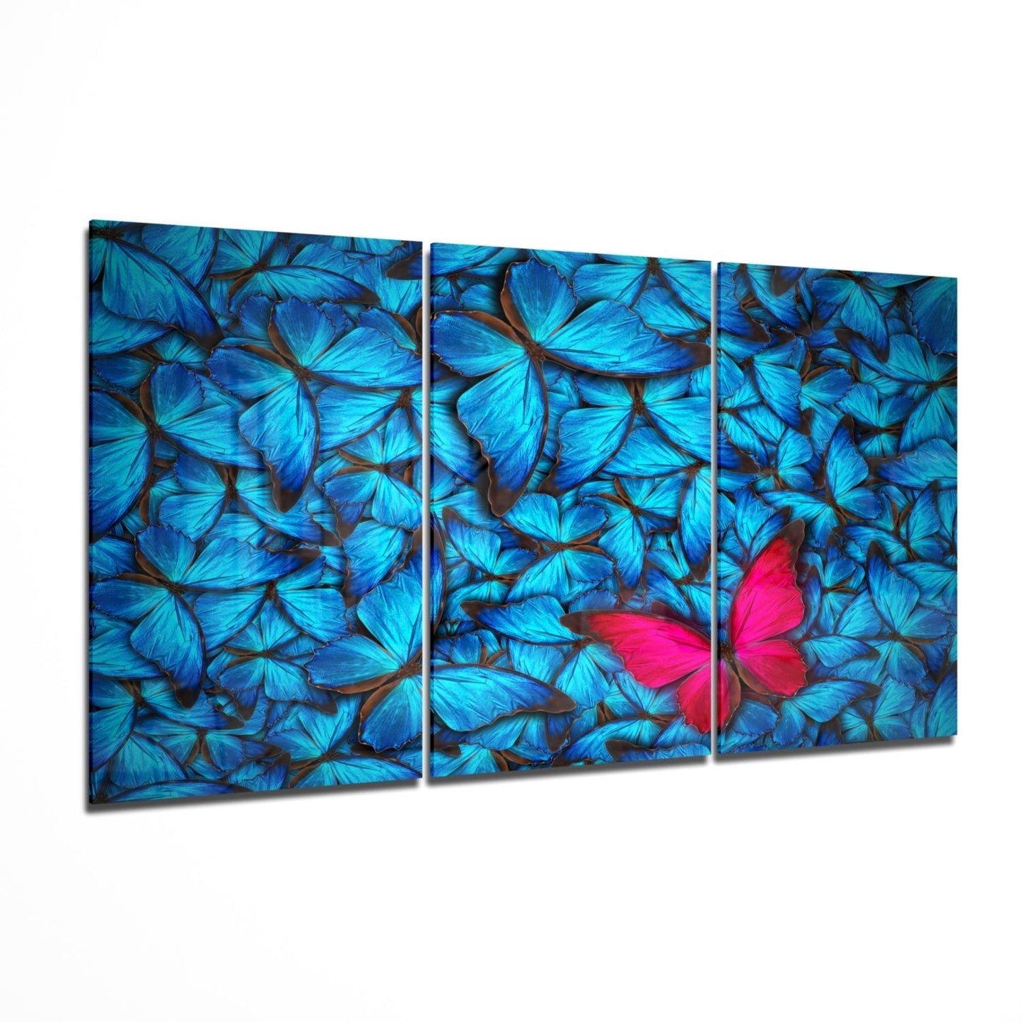 Three-panel glass wall art displaying vibrant blue butterflies with one bright pink butterfly as focal point, angled perspective view.