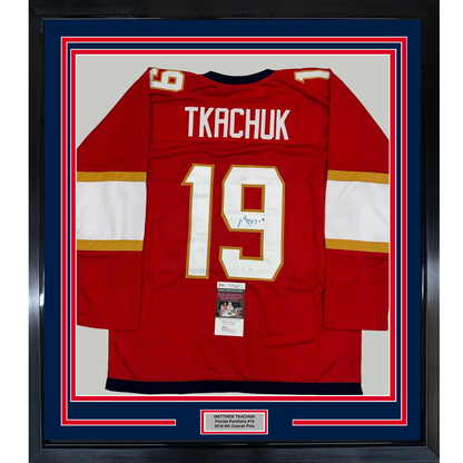 Framed red Florida Panthers hockey jersey number 19 with "TKACHUK" nameplate and signature, displayed front-facing with JSA authentication certificate visible.