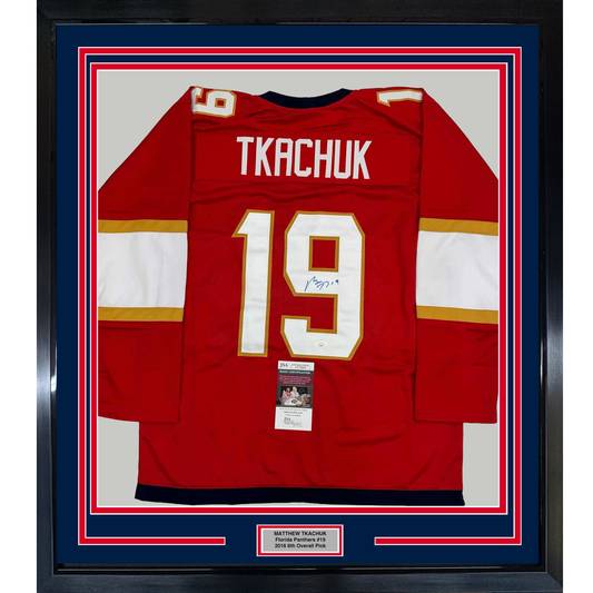 Framed red Florida Panthers hockey jersey number 19 with "TKACHUK" nameplate and signature, displayed front-facing with JSA authentication certificate visible.