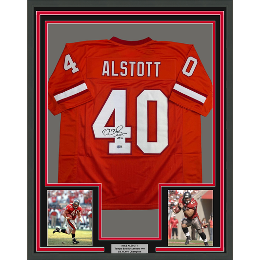 Red Tampa Bay Buccaneers jersey number 40 with "ALSTOTT" nameplate, signed, displayed in frame with two action photos below.