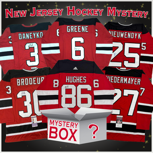 Six signed red New Jersey Devils jerseys displayed flat featuring players Daneuko, Greene, Nieuwendyk, Brodeup, Hughes, and Wiedermayer, with a mystery box centered below.