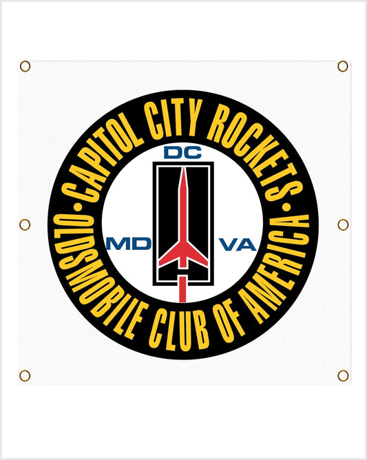 Front view of a white banner showing a black roundel with yellow "Capitol City Rockets" lettering and a red rocket.