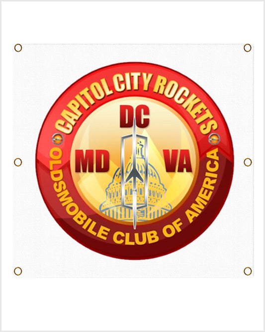 Straight-on view of a red and gold badge reading Capitol City Rockets, DC, MD and VA, on white vinyl with grommets.