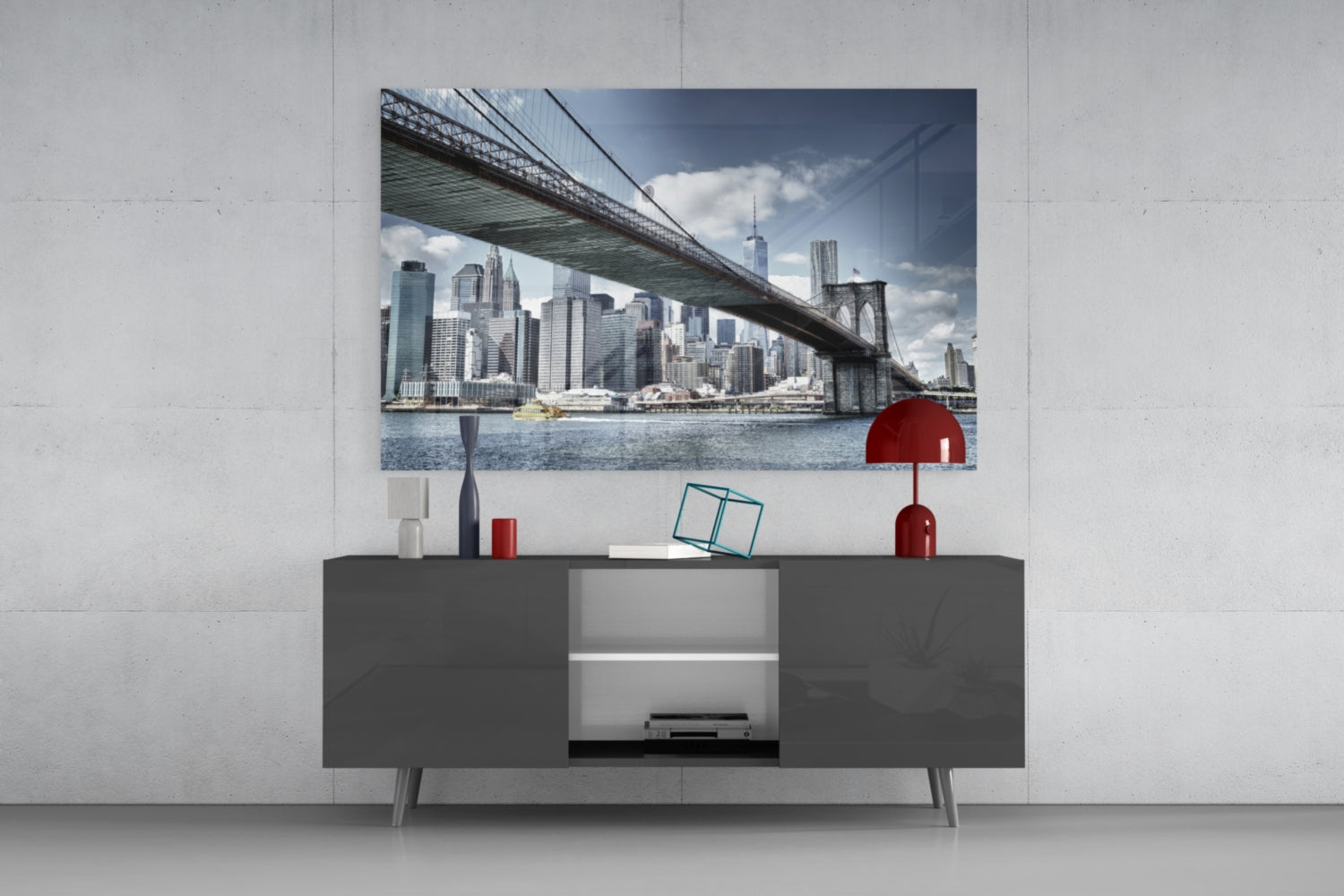 Glass wall art depicting Manhattan Bridge and NYC skyline displayed above dark gray media console in modern interior setting.