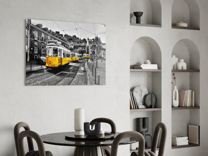 Yellow tram glass wall art displayed above a round black dining table in a modern interior with arched shelving.