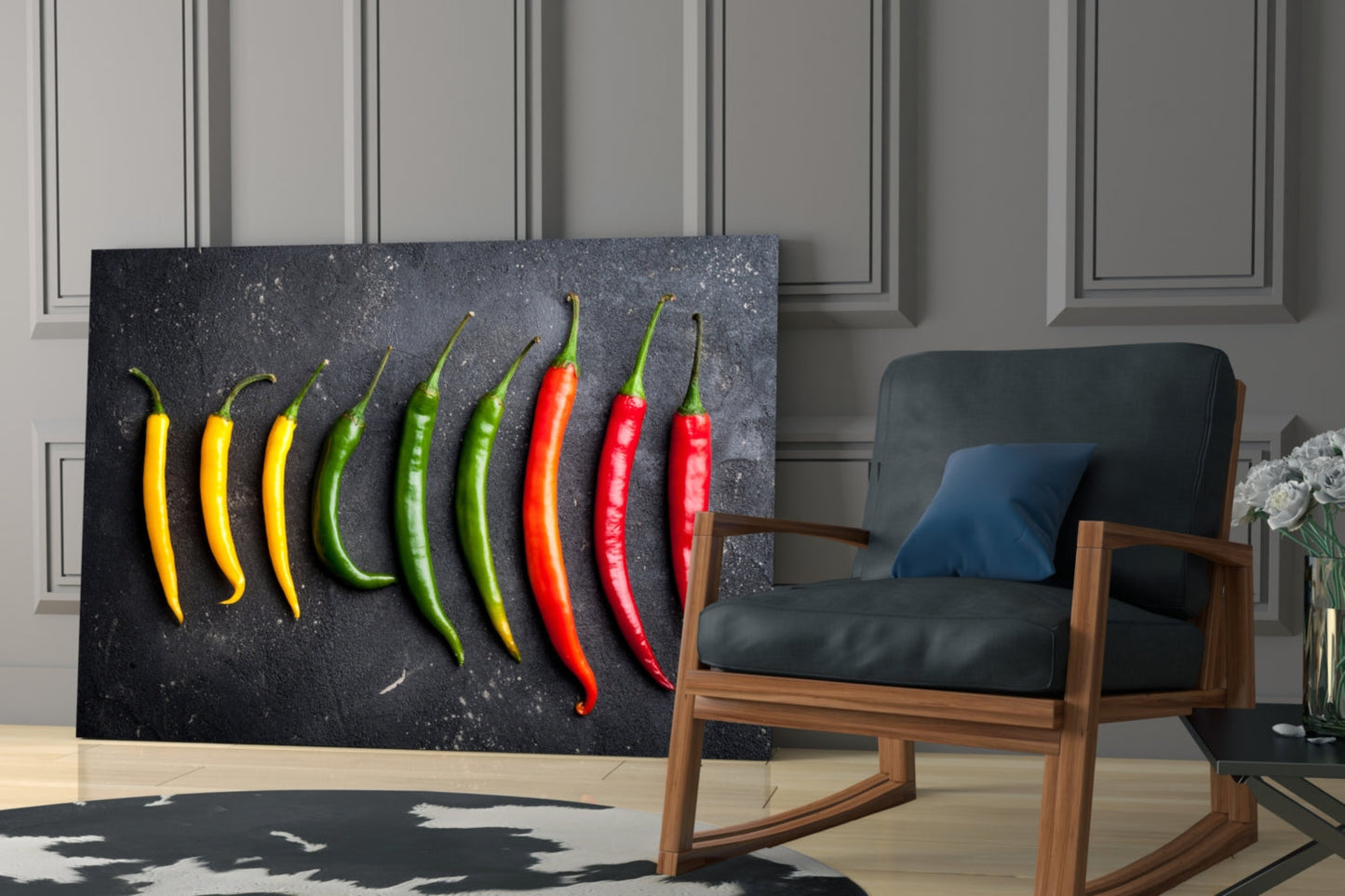 Black glass wall art displaying nine chili peppers in yellow, green, and red arranged in a modern living room setting.