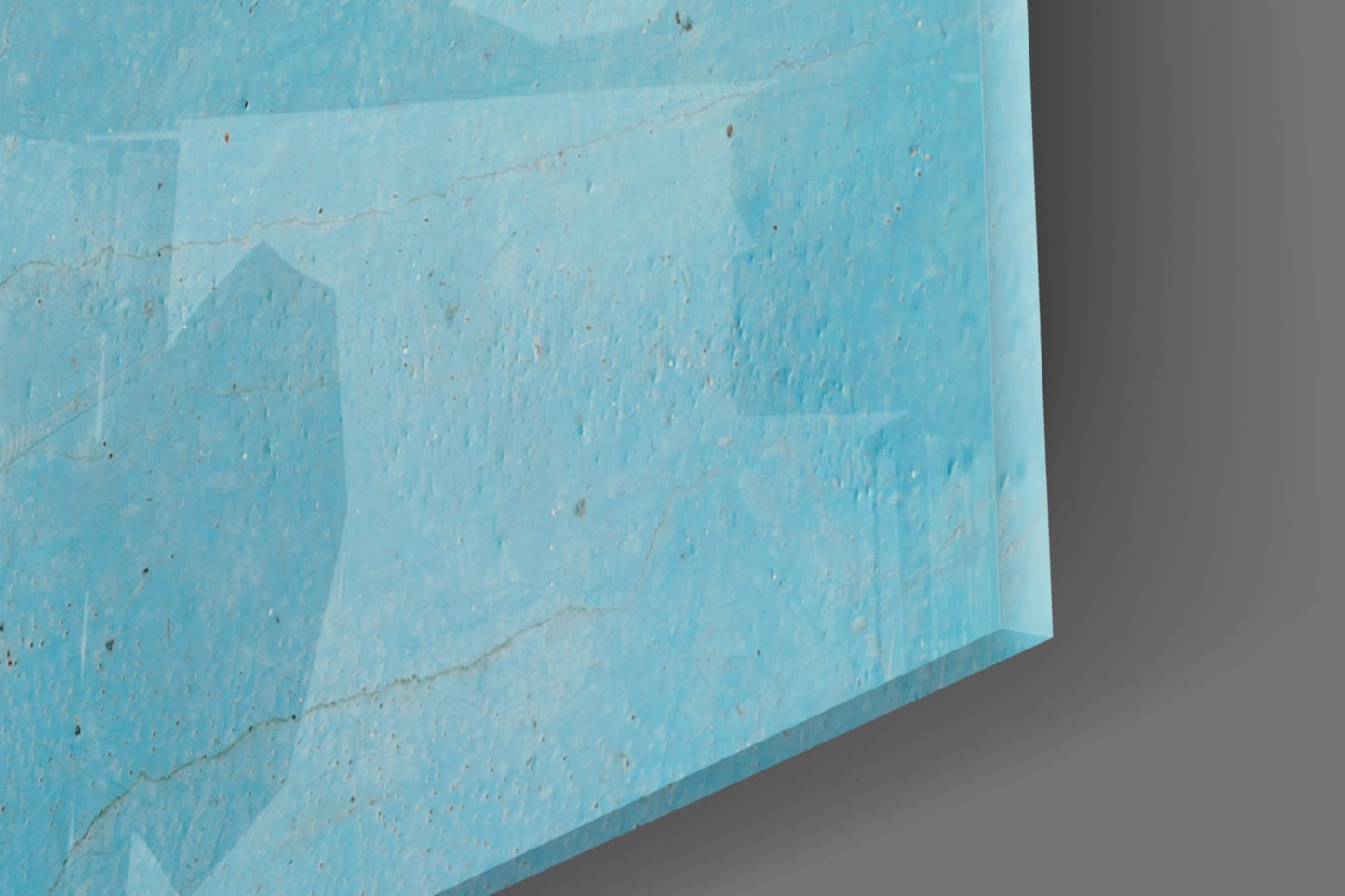 Close-up angled view of light blue textured glass panel showing surface detail and layered edges against gray background.