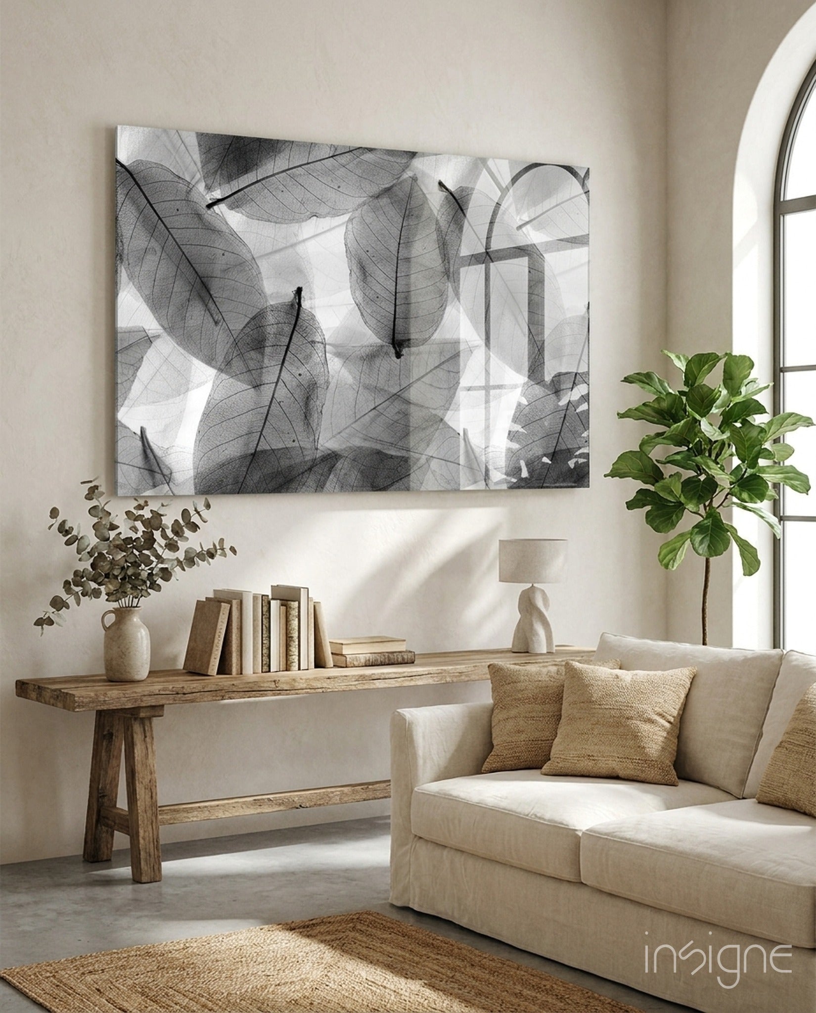 Black and white translucent leaf pattern glass wall art displayed above wooden console table in minimalist living room interior.