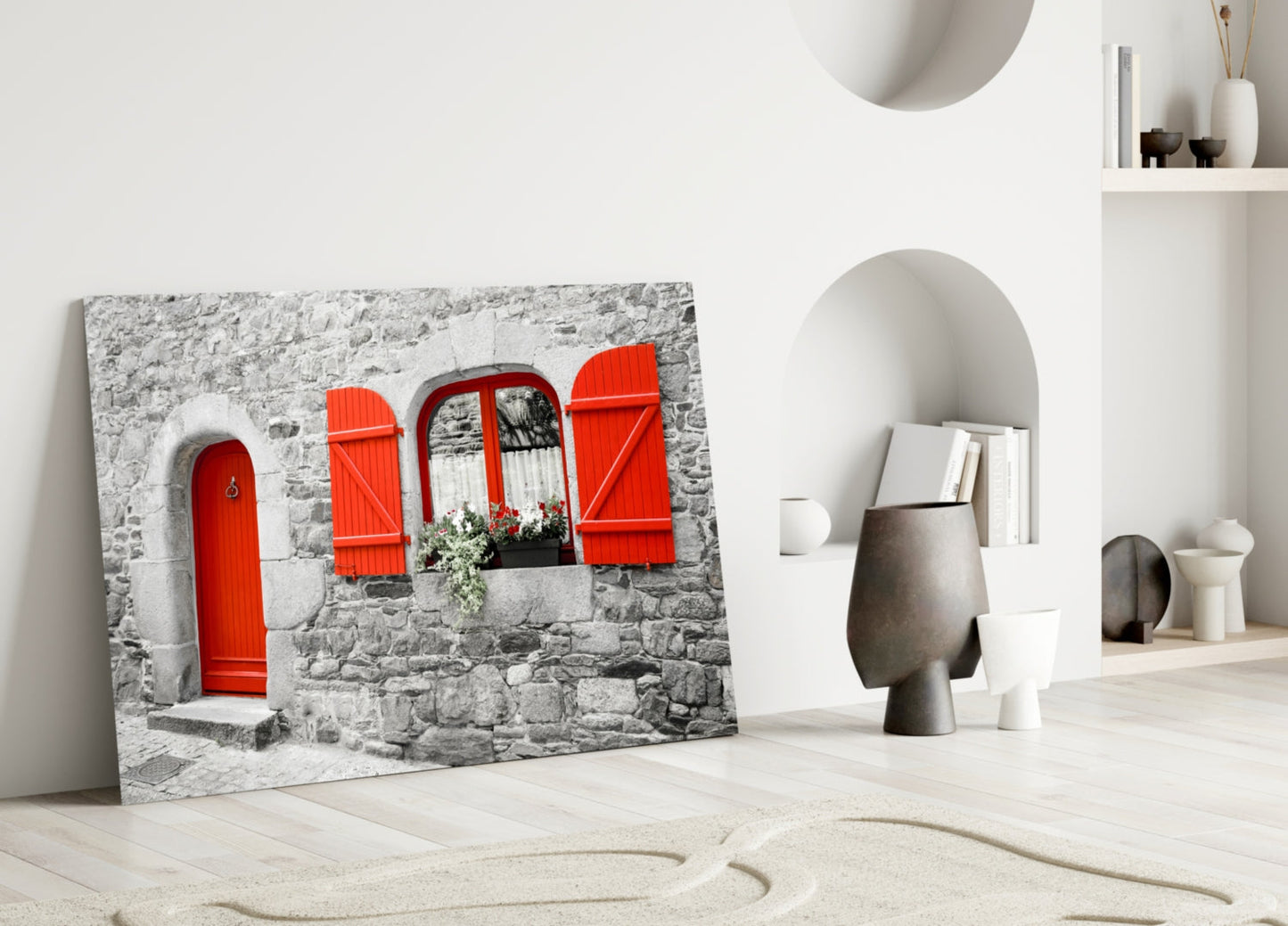 Red Door Glass Wall Art leaning against white wall beside decorative ceramic vessels and shelving unit.