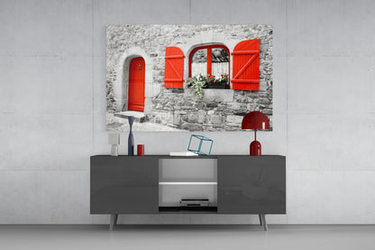 Red Door Glass Wall Art displayed above a dark grey media console in a modern living room setting with white walls.