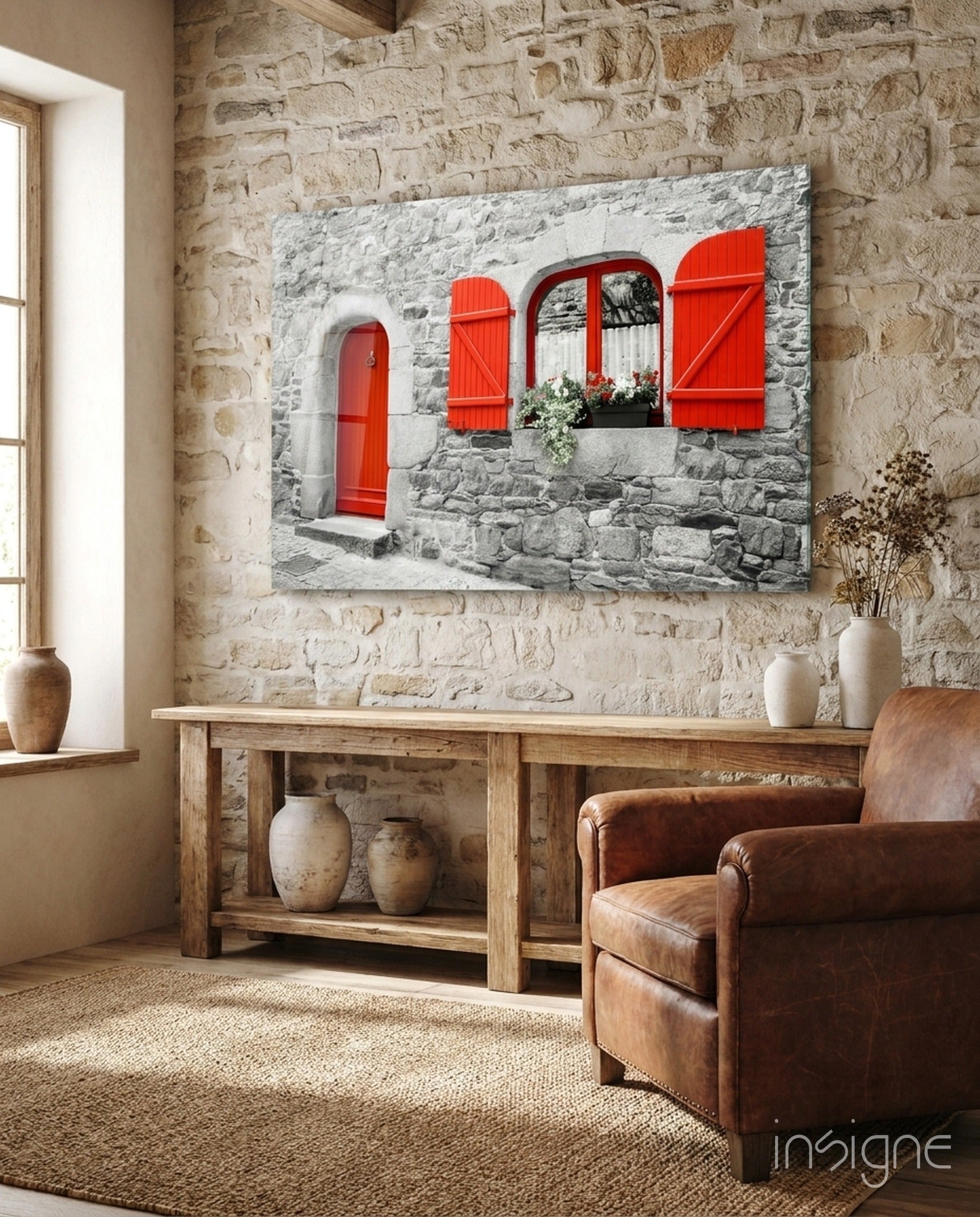 Red Door Glass Wall Art displayed above wooden console table in stone-walled room with leather chair.