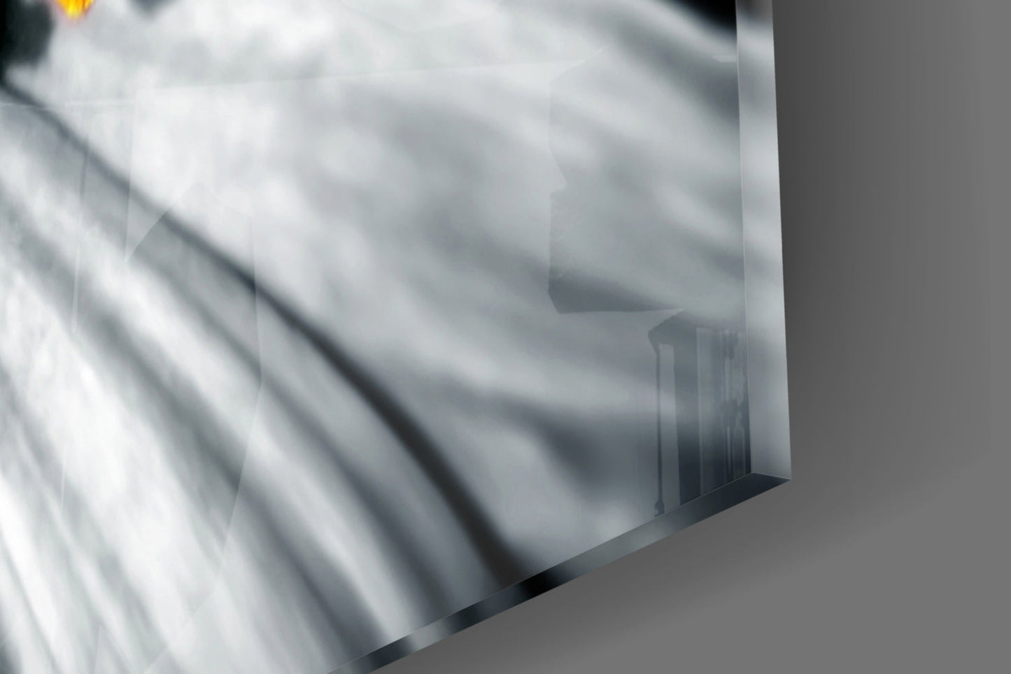Close-up angled view of translucent glass wall art panel with frosted bee design and black edge detail.