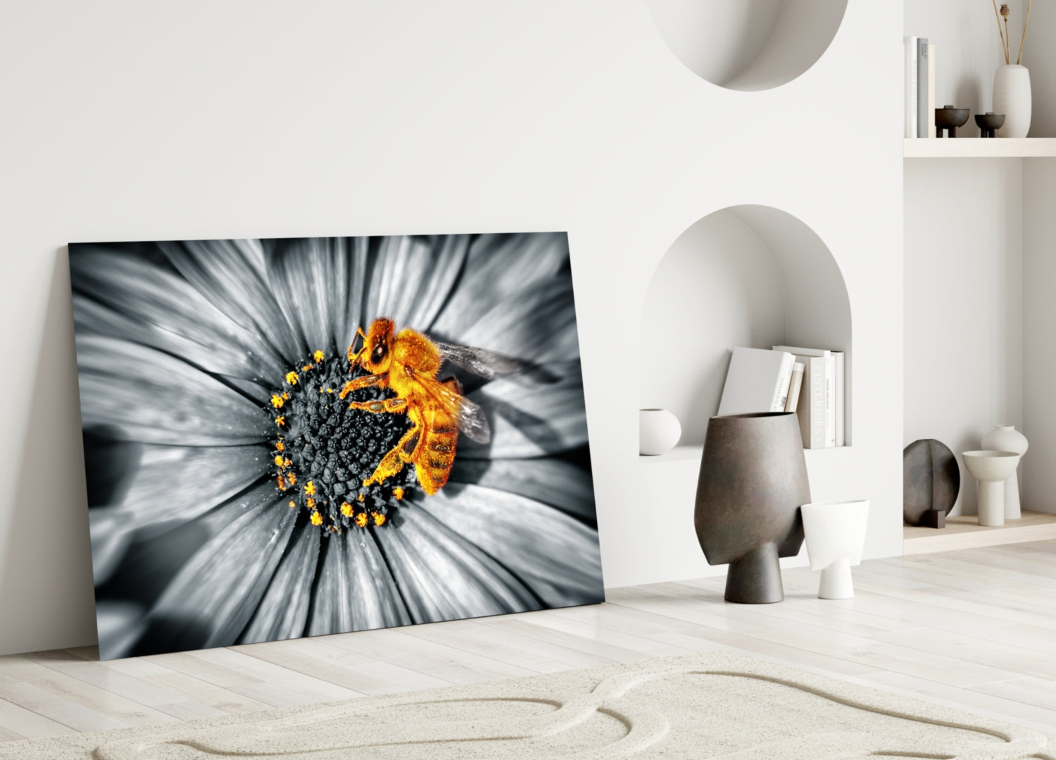 Honey Bee Glass Wall Art leaning against white wall in minimalist room, displaying bee on yellow flower with grayscale petals.