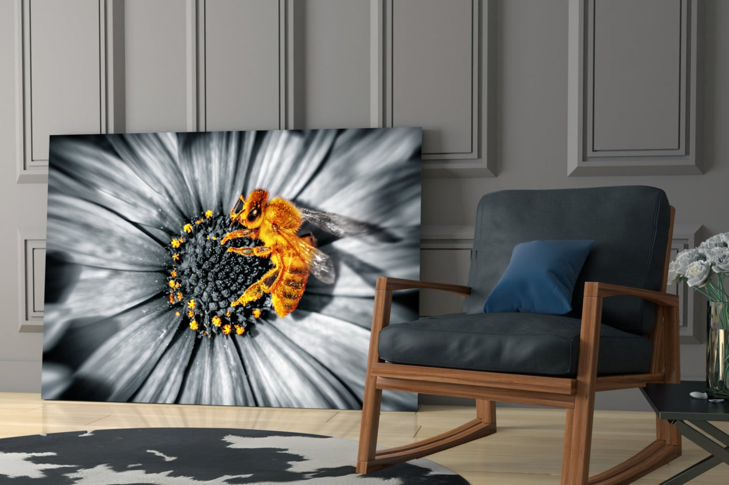 Honey bee glass wall art displayed in a modern living room beside a wooden chair, showing a bee on a white flower with motion-blur effect and selective color.