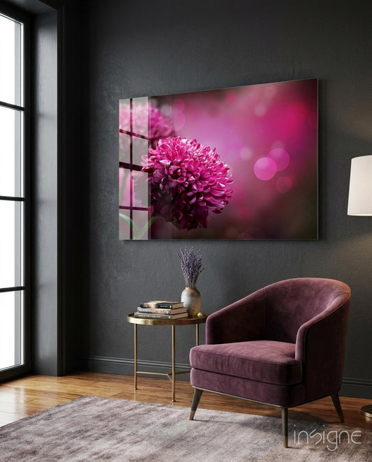 Magenta pompom dahlia glass wall art displayed above a side table in a modern living room with purple velvet chair.