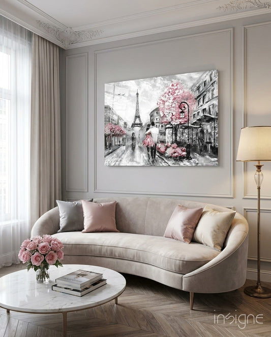 Gray-scale Paris street scene with pink cherry blossoms and couple with umbrella displayed above beige curved sofa in elegant living room.