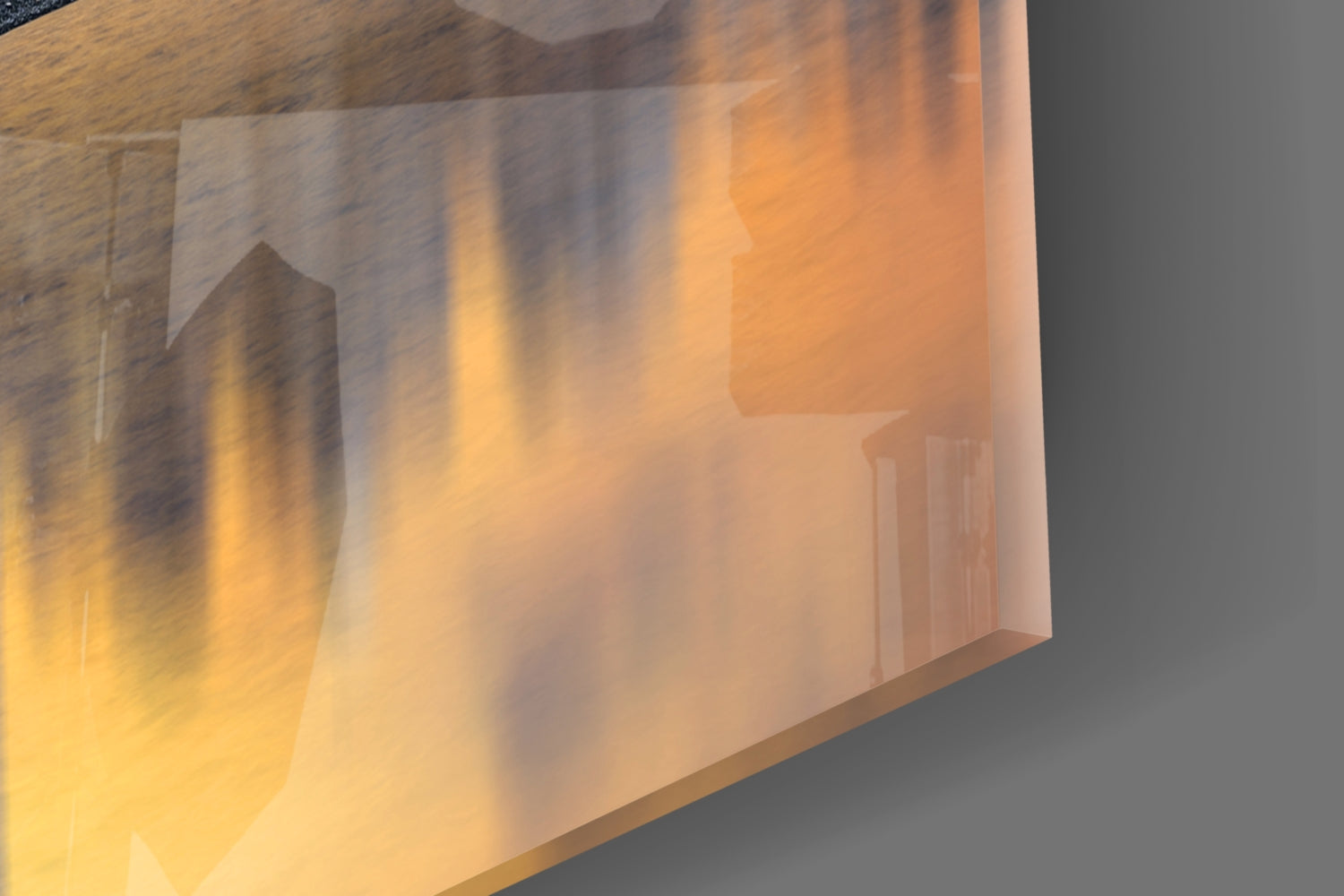 Translucent glass wall art panel with warm amber and orange tones displaying urban architectural silhouettes, angled view.