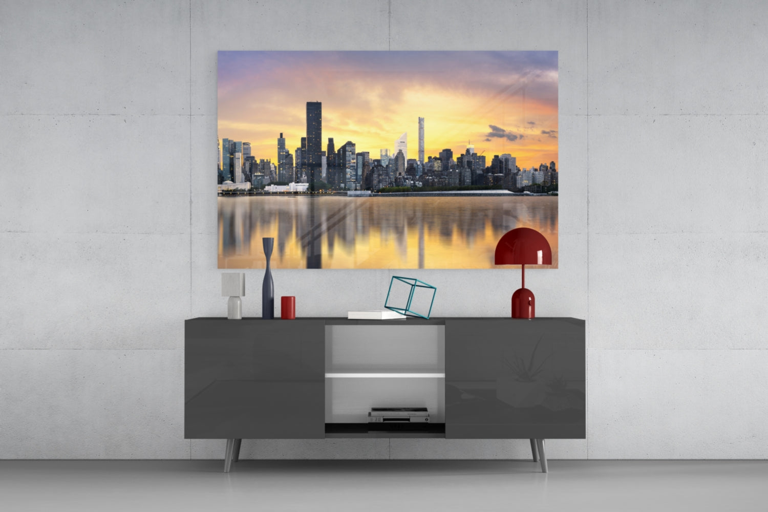 Downtown Glass Wall Art displaying Manhattan skyline at sunset mounted above dark gray media console with red decorative accents.