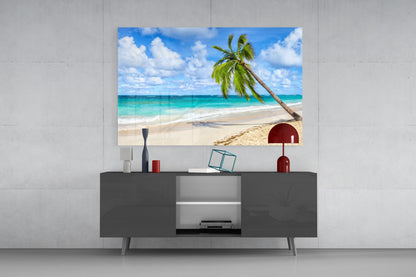 Tropical beach glass wall art with palm tree and turquoise ocean displayed above dark media console in modern living room.