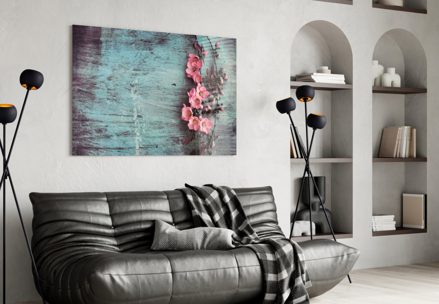 Pastel Flower Glass Wall Art featuring pink roses on turquoise distressed wood displayed above a black leather sofa in a modern living room interior.