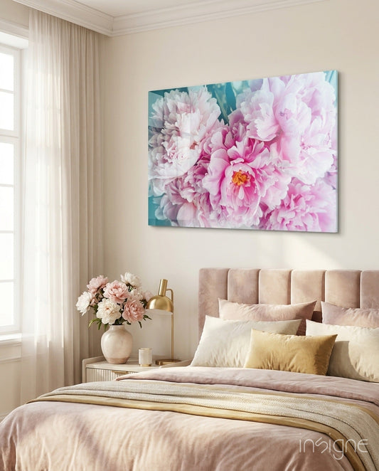 Pink peony canvas art displayed above a beige upholstered headboard in a bedroom with matching floral bedding.