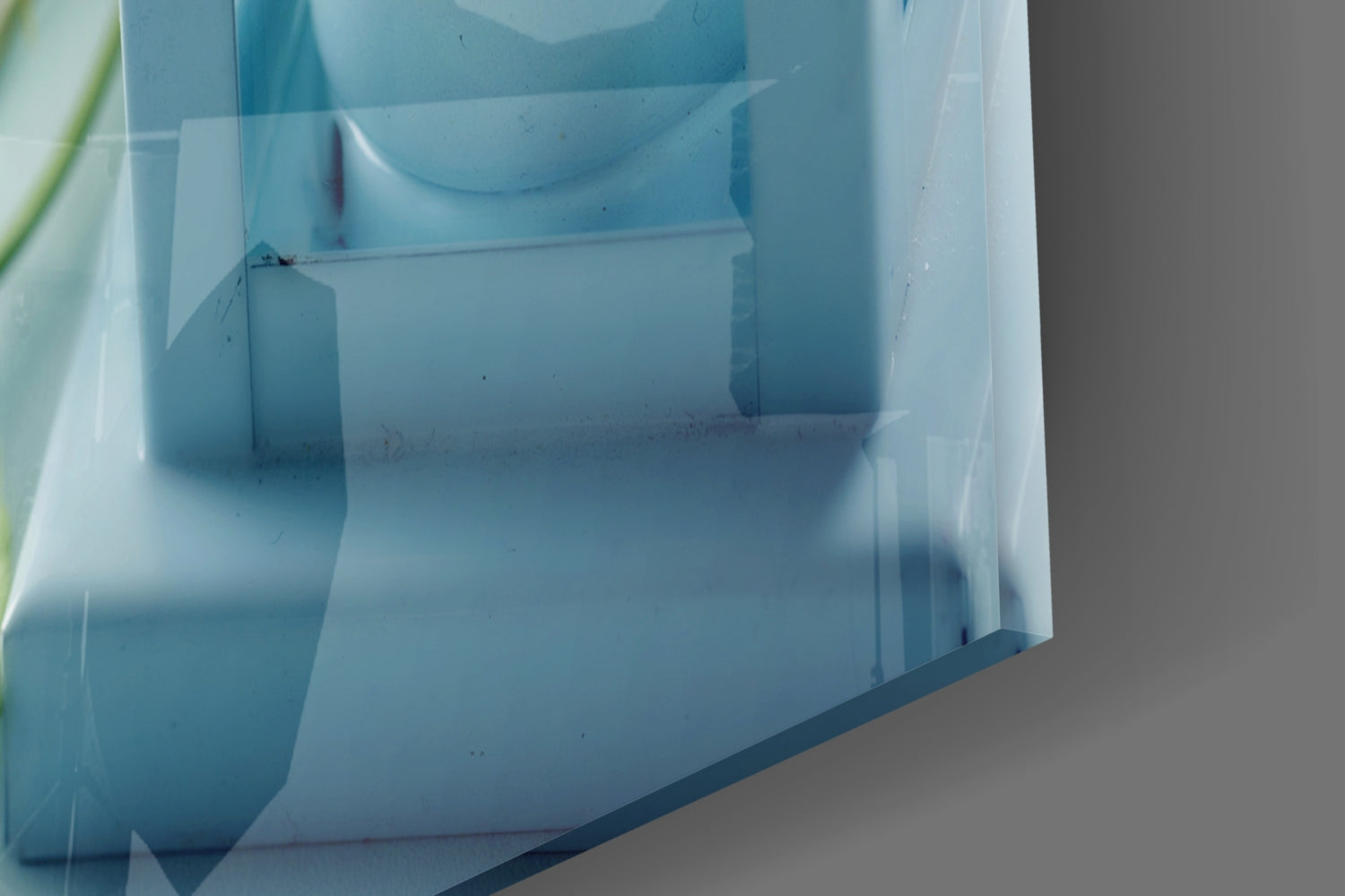 Close-up interior view of translucent blue acrylic box showing compartments and molded dividers.