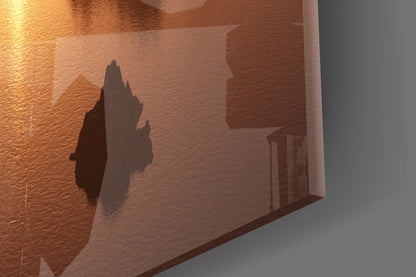 Amber Sunset Jagged Peaks Over Water Glass Wall Art