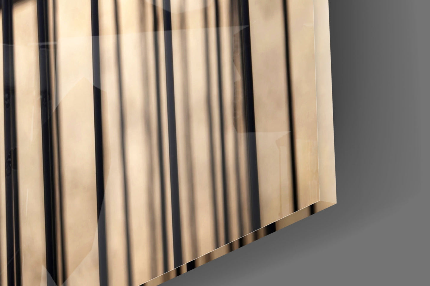 Close-up angled view of translucent glass panels with vertical black lines creating a birdcage pattern against gray background.