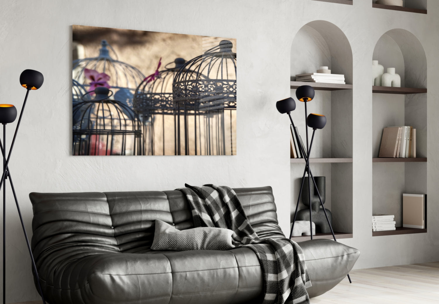 Birdcage glass wall art displayed above a gray leather sofa in a modern living room with built-in shelving.