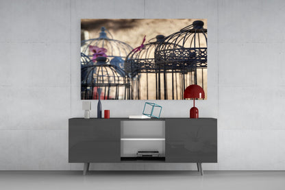 Birdcage Glass Wall Art displayed above a dark gray media console with red decorative accessories and white shelving.