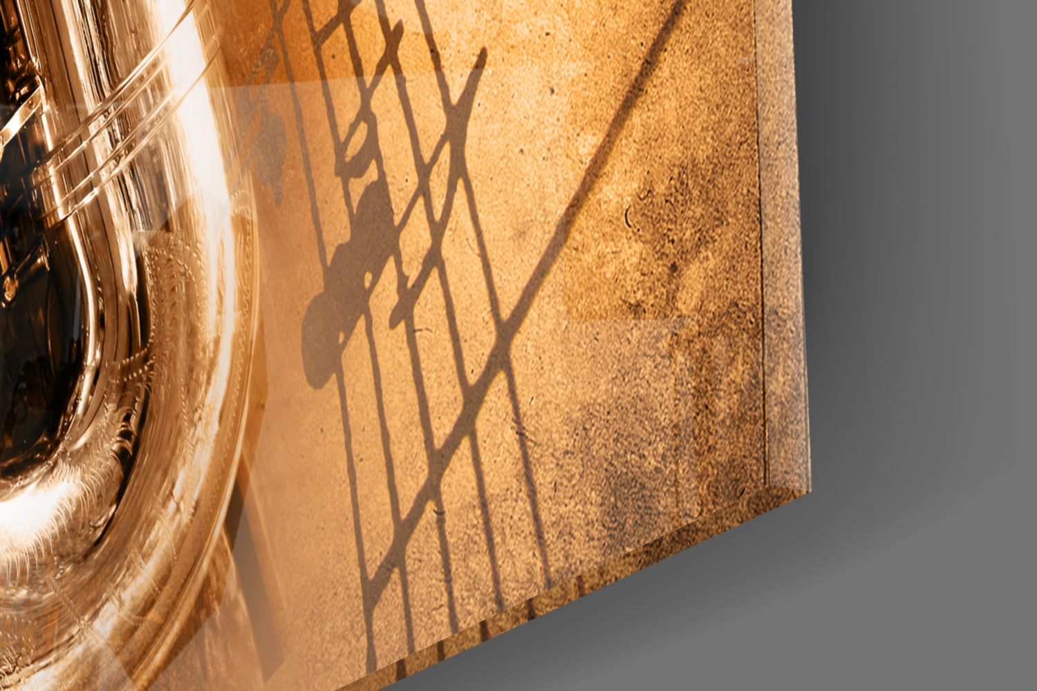 Close-up of textured cork surface with shadow silhouette of saxophone and musical notes cast by amber glass panel on left.