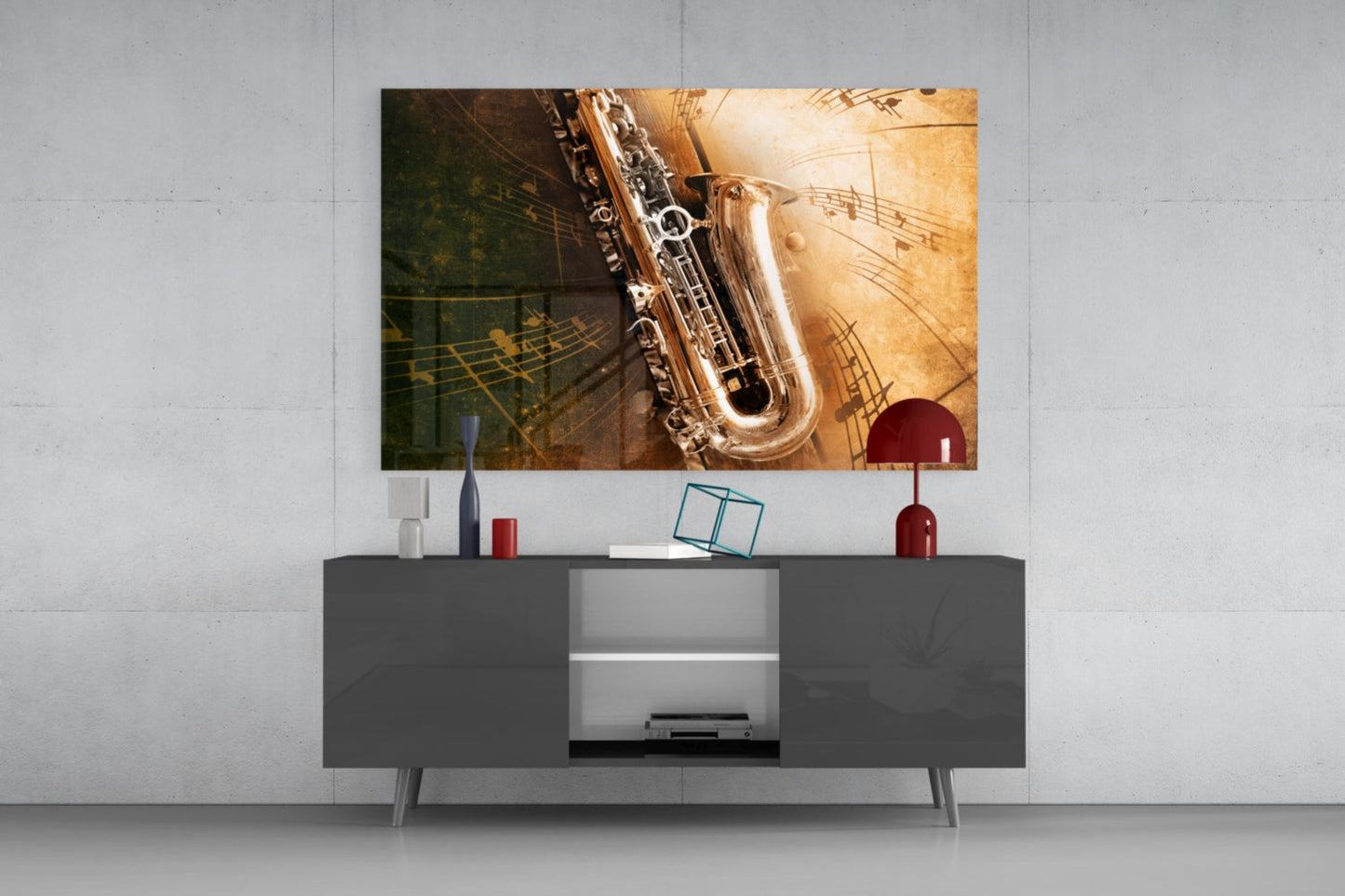 Saxophone glass wall art displayed above a dark gray media console, showing a golden saxophone with musical notes on warm-toned background.