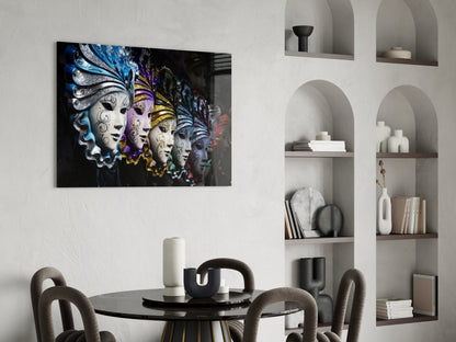 Venetian Carnival Masks glass wall art displayed above a black round dining table with gray chairs in a modern interior with white shelving.