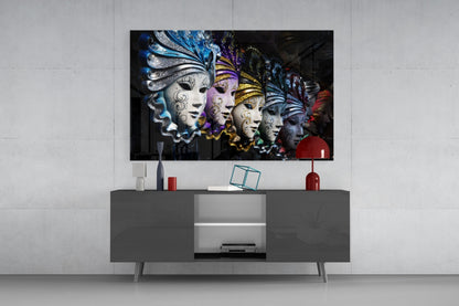 Venetian Carnival Masks glass wall art displayed above gray media console, showing five ornate masks in blue, purple, gold, and white with elaborate headdresses against dark background.