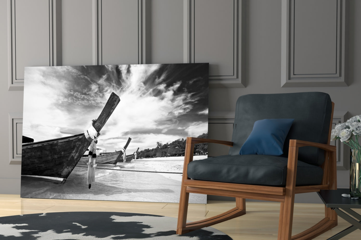 Black and white glass wall art depicting wooden boats on a beach displayed in a modern living room setting.