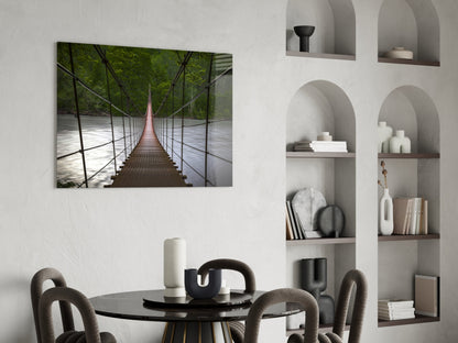 Suspension bridge glass wall art displayed above a black round dining table in a modern interior with arched wall niches.
