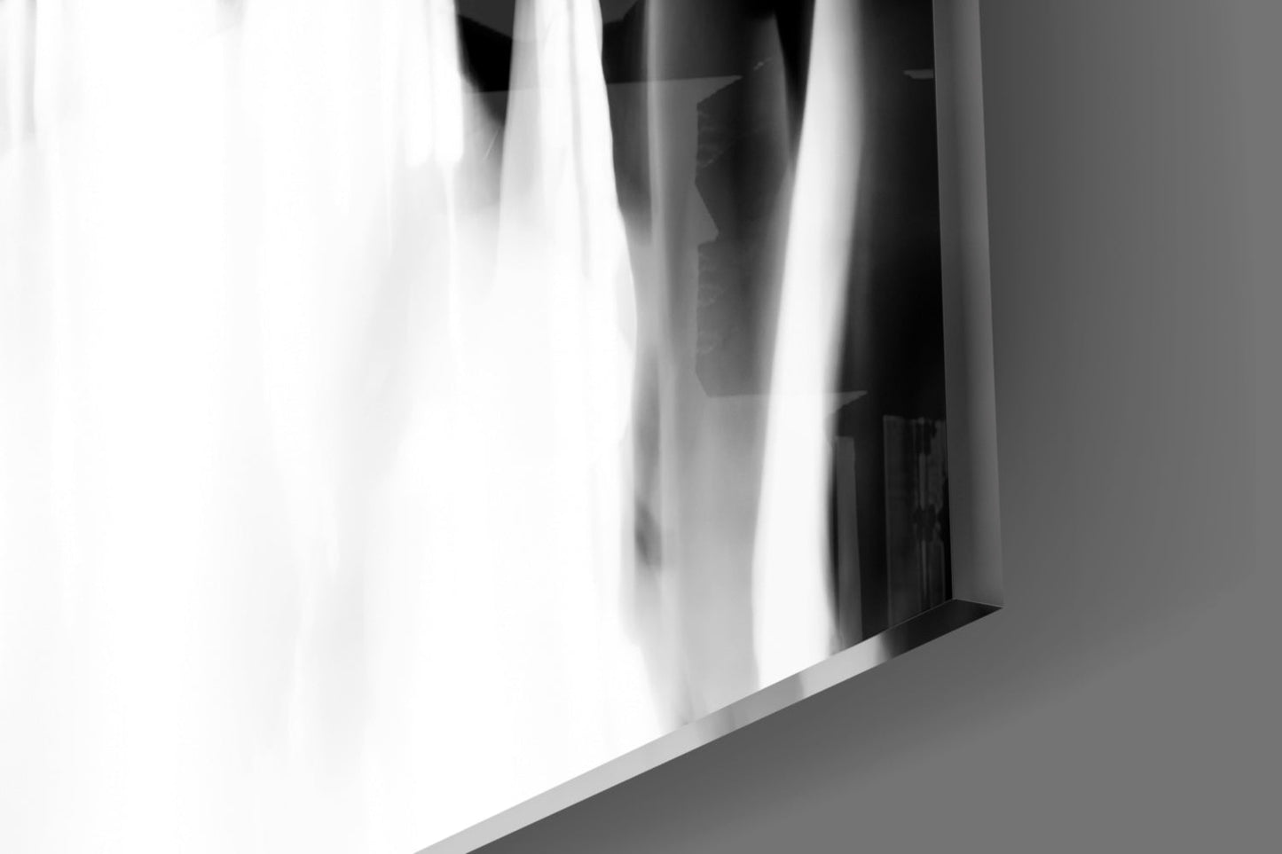 Close-up angled view of translucent white glass panel with blurred crowd silhouettes visible through it, against gray background.