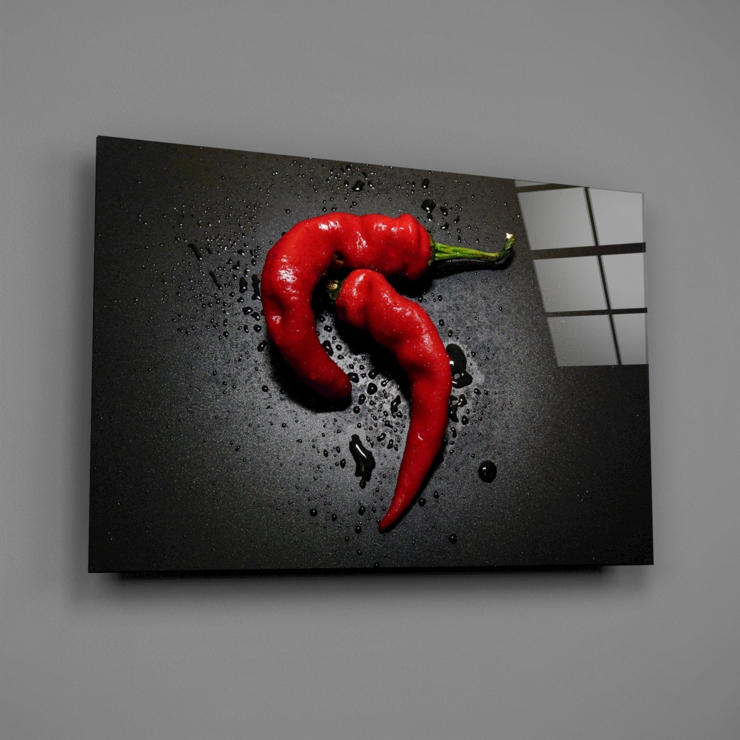 Angled view of red pepper glass wall art on gray background with water droplets and grid pattern visible on right edge.