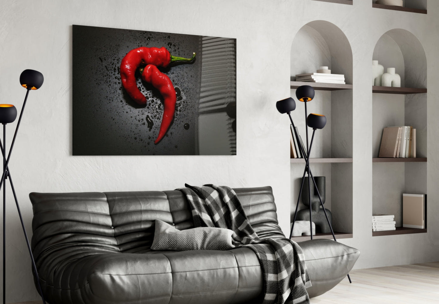 Red pepper glass wall art displayed above a black leather sofa in a modern living room with arched shelving.