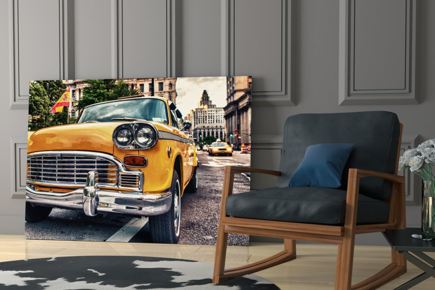 Glass wall art featuring a bright yellow vintage taxi cab on a city street, displayed in a modern living room next to a wooden rocking chair.