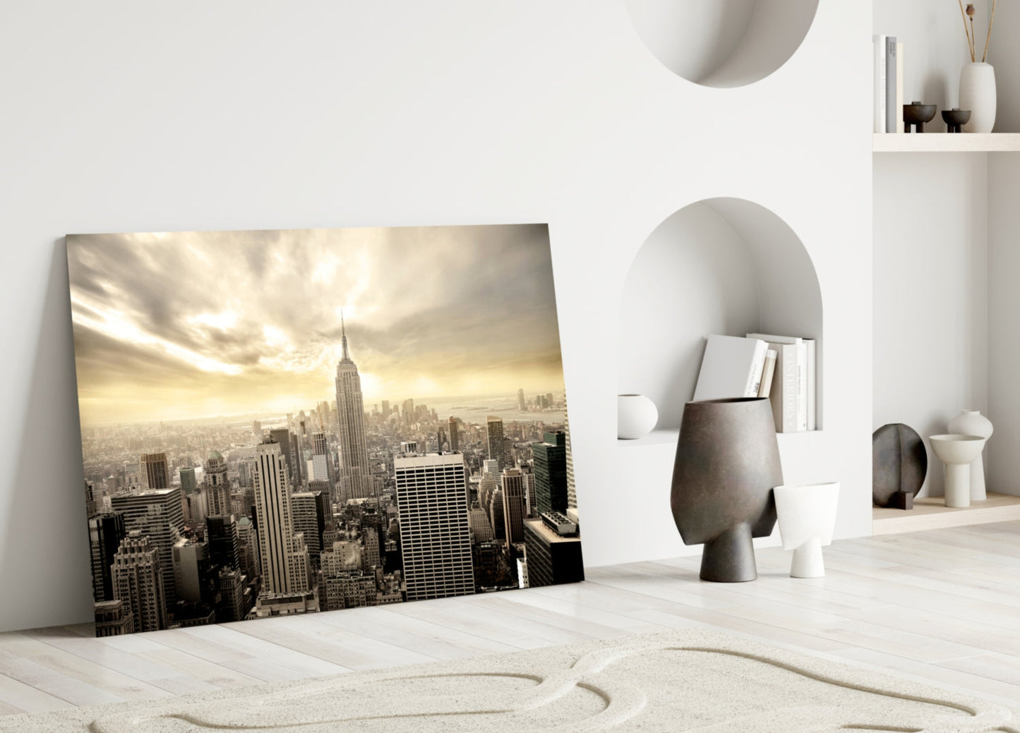 NYC glass wall art leaning against white wall showing sepia-toned Manhattan skyline with Empire State Building.