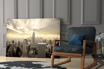 New York City skyline glass wall art displayed in modern living room with wooden chair and blue cushion.