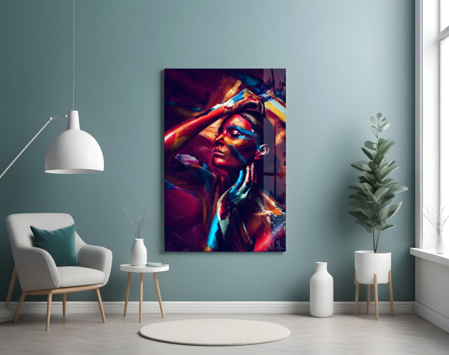 Vibrant glass wall art depicting a woman's portrait in bold reds, blues, and golds, displayed in a minimalist room setting.